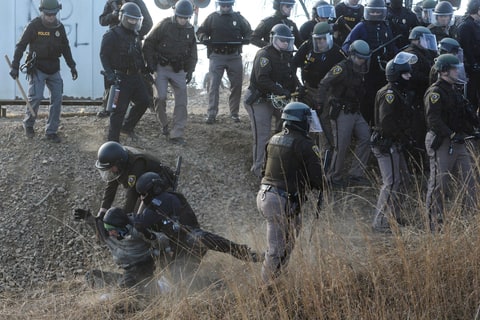 Police detain a protester during a protest in Mandan against plans to pass the Dakota Access pipeline near the Standing Rock Indian Reservation, North Dakota, U.S. November 15, 2016.