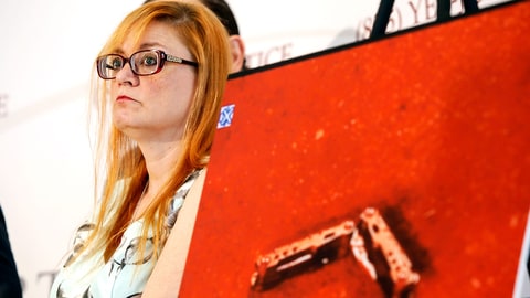 Lynne Schultz, mother of Scout Schultz, stands beside an enlarged photograph of a multipurpose tool at a news conference in Atlanta, Ga., Monday, Sept. 18, 2017. Scout was a 21-year-old Georgia Tech student who was shot and killed while holding the tool during a confrontation with police on campus Saturday, Sept. 16. (Casey Sykes/Atlanta Journal-Constitution via AP)