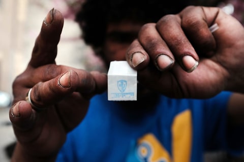 Eliezer, a 38 year old homeless heroin addict, holds a bag of heroin in the Bronx on May 4, 2018 in New York City. Eliezer often snorts his heroin instead of injecting as he feels it lessens the chances of overdosing on the drug.