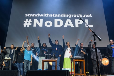 Time Reynolds and Dave Matthews stand with eh Standing Rock Indian Tribe on stage at the Stand With Standing Rock charity concert at DAR Constitution Hall in Washington, D.C.