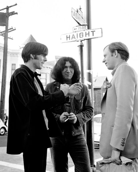 Jerry Garcia (c) and Rock Scully (L), manager of the rock band the Grateful Dead, speak to author Tom Wolfe at the corner of Haight and Ashbury in the 1960s.