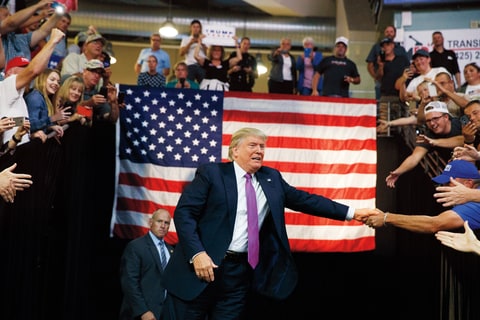 Republican presidential candidate Donald Trump shakes hands as he arrives to a campaign rally at Xfinity Arena of Everett, Tuesday, Aug. 30, 2016, in Everett, Wash.