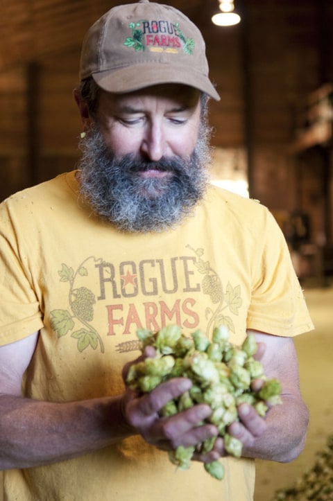 Brewmaster John Maier inspects Rogue Farms hops.