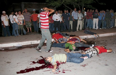 A man reacts at a crime scene where eight people were killed by hitmen in the city of Navolato, some 25 km (16 miles) away from Culiacan, in the Mexican state of Sinaloa August 30, 2009. A group of youths, who were gathered in one of the main thoroughfares of Navolato, were shot by unknown assailants travelling in two vehicles, according to local media. Six men and two women were killed and four more were taken to a hospital with several injurie