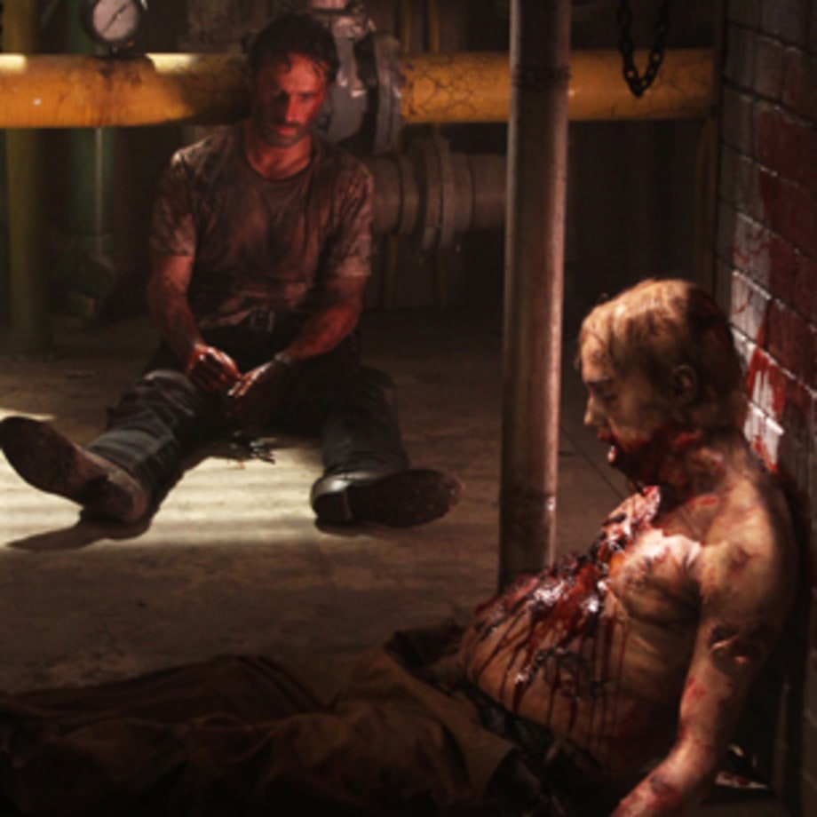 Rick stabs the distended-belly zombie