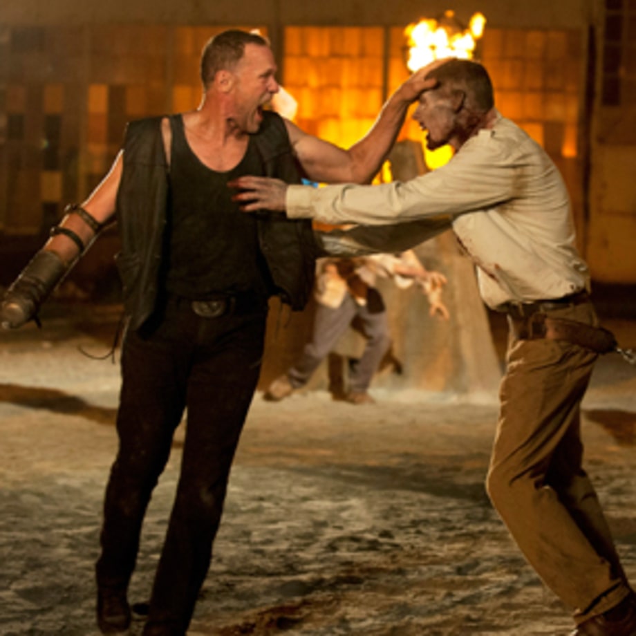Merle pulls out the zombie's teeth