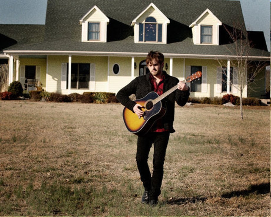 Caleb Followill Playing Guitar In Front of House