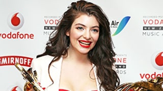 Lorde Sexes Up Her White Suit With a Festive Ab-Baring Crop Top, Pulls a Taylor Swift