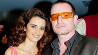 Penelope Cruz Straddles Bono While Husband Javier Bardem Struts in Feather Boa During U2 Concert: Watch