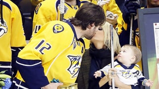 Carrie Underwood Kisses Husband Mike Fisher Rinkside While Baby Isaiah Looks On
