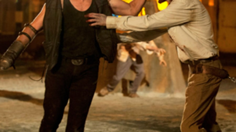 Merle pulls out the zombie's teeth