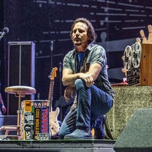 Eddie Vedder, Roger Waters, Pharrell Take Knee Onstage in Protest